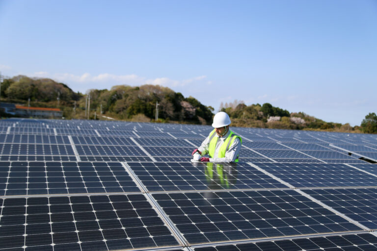 Engineer at solar park with pyranometer